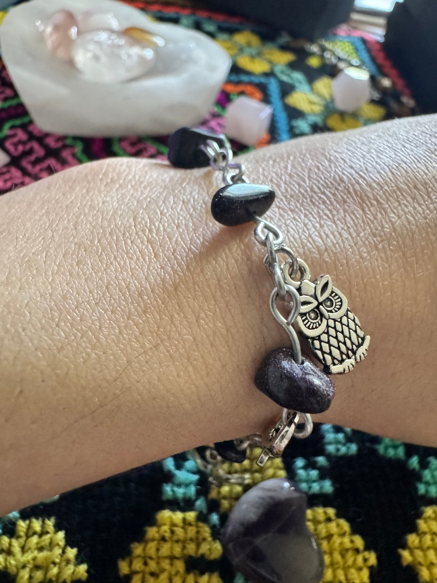 Goldstone charm bracelet with black shimmering beads and creatures of the night charms.