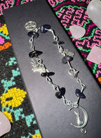 Goldstone charm bracelet with black shimmering beads and creatures of the night charms.