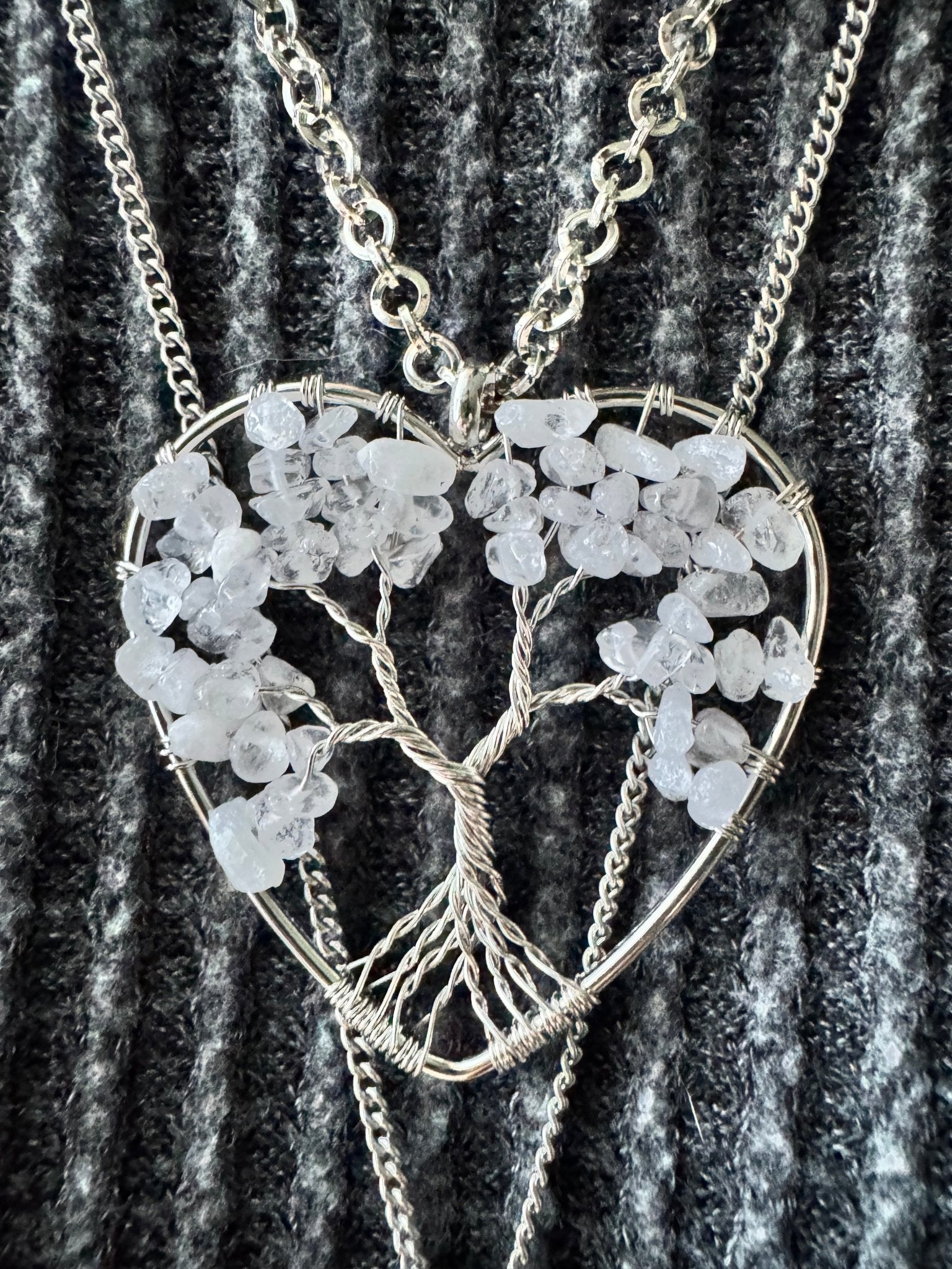 Quartz Tree of Life necklace suspended in a raw crystal heart with natural stone texture
