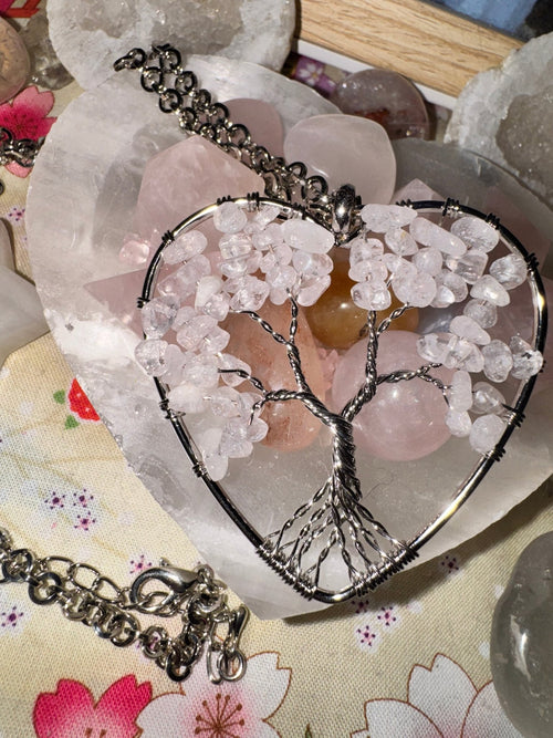 Quartz Tree of Life necklace suspended in a raw crystal heart with natural stone texture