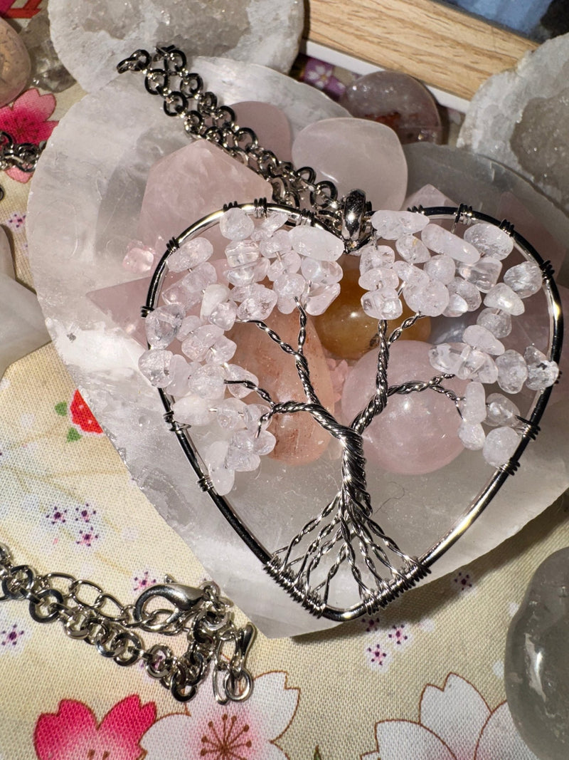 Quartz Tree of Life necklace suspended in a raw crystal heart with natural stone texture