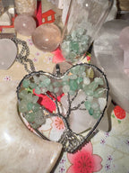 Quartz Tree of Life necklace suspended in a raw crystal heart with natural stone texture
