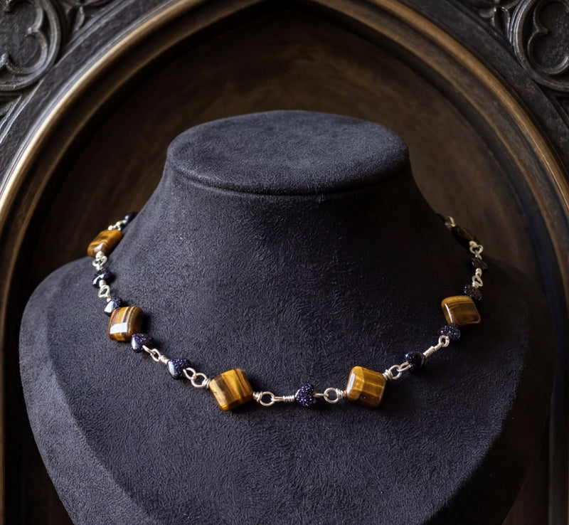 Faceted tiger’s eye and goldstone choker necklace with warm bronze tones and hidden clasp.