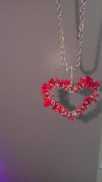 Red coral pendant necklace with stainless steel rope chain and vibrant natural texture.