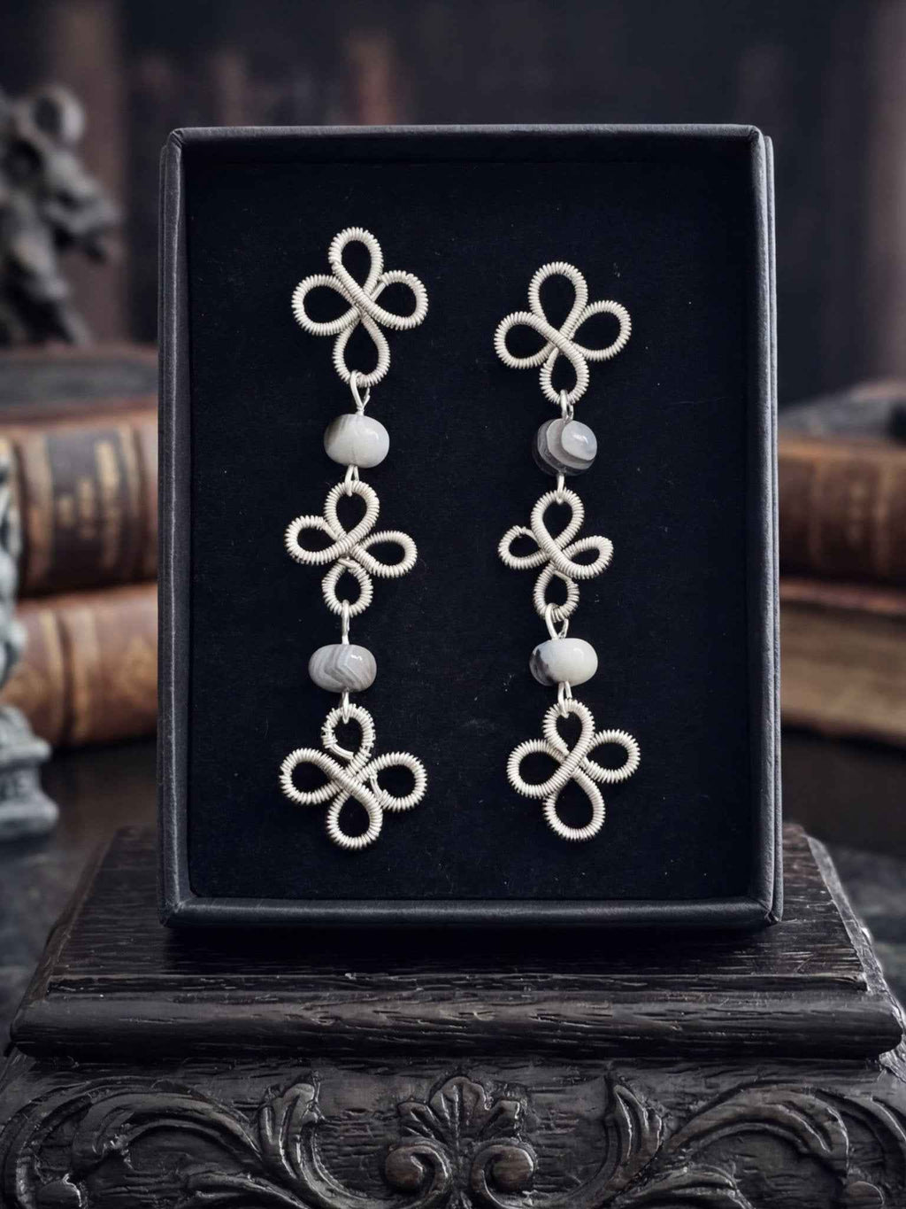 Silver clover wire wrapped earrings with Botswana Agate beads in a gothic setting.